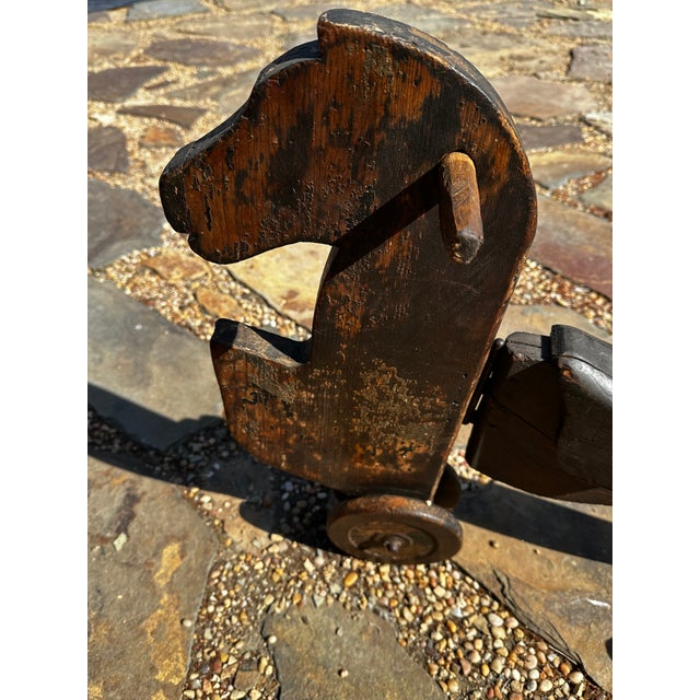 What you have is an antique folk art wooden ride-on horse tricycle — a child's riding toy, likely dating from the late...