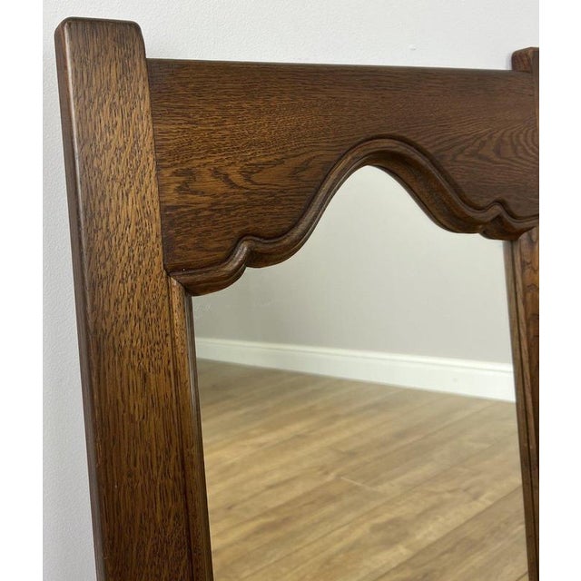 A charming Vintage French mirror showcasing a beautifully crafted oak frame with elegant curves and subtle carved...