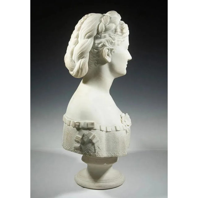 Victorian Portrait of a Lady with coiffed hair, low-cut bodice having ribbon and blossom trim, carrara marble, rests on...