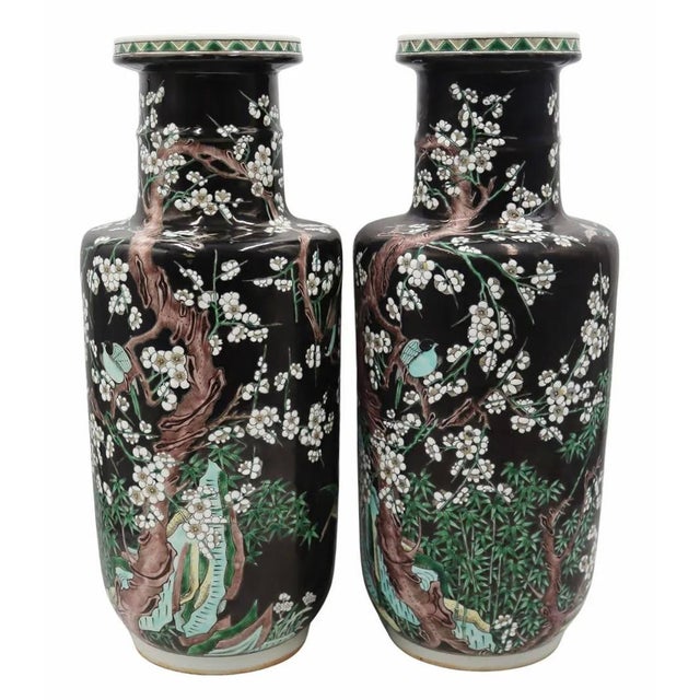A fantastic pair of detailed and dramatic porcelain vases, the main decorative element comprised of mirrored flowering...