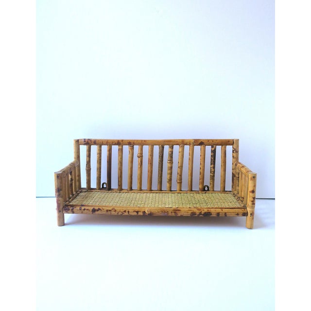 A rectangular wicker and bamboo wall shelf, circa mid to late-20th century. Hooks on back for hanging.