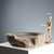 Circular stone basin with shallow well and pouring spout. This piece is attributed to the mentioned designer/maker. It has...