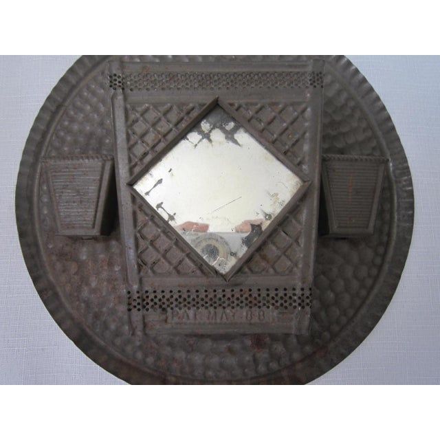 Tin Metal matchstick Holder from the 20"s. Wall mount with a single hole, it has a tiny mirror in the center. It measures...