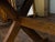 An English oak sawbuck farm table from the 19th century, with double X-Form base, plain cross stretcher and great rustic...