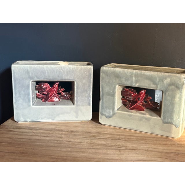 A pair of McCoy Pottery Arcature vases, introduced in 1951. Each has a rectangular frame form with an open center window....