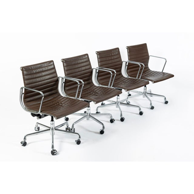 This set of four authentic Eames for Herman Miller Aluminum Group Thin Pad office chairs were manufactured in 2008 (50...