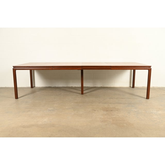 An exceptional Mid-Century Modern extension dining table in book-matched walnut By Edward Wormley for Dunbar Furniture,...