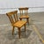 Pair of vintage Scandinavian-style solid pine dining chairs featuring a clean, minimalist silhouette and beautifully...