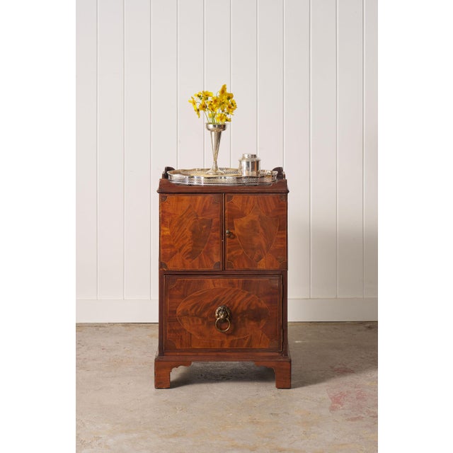 Georgian mahogany night cabinet with an inlaid gallery top, paneled door, and interior shelf.