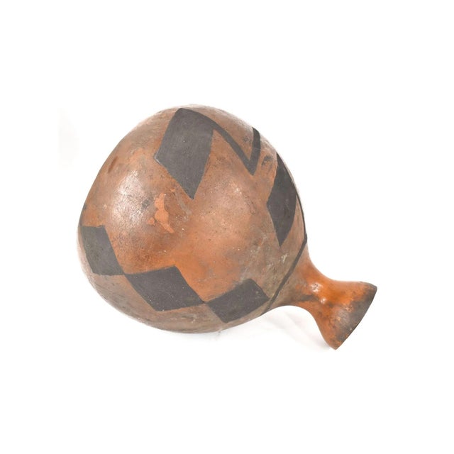 The ceremonial gourd vessel, crafted by the Tutsi people of Rwanda, stands as a significant artifact representing the rich...