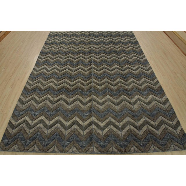 This contemporary geometric Moroccan Chevron rug is hand-knotted with an all-wool high-low pile on a cotton foundation....