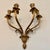 A striking and exceptionally substantial vintage Rococo Revival/Hollywood Regency brass four-arm wall sconce featuring...
