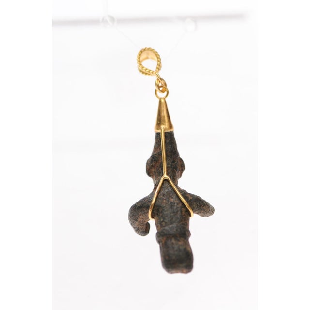 A charming bronze figure from the Ancient Roman Empire fashioned into a pendant trimmed with 18 karat gold accents and...