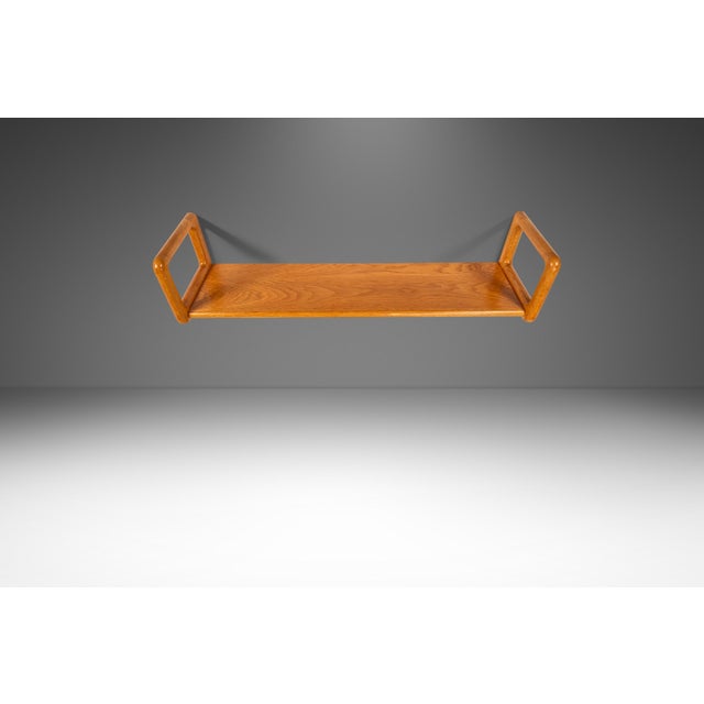 Introducing a splendid Danish Modern wall-hanging shelf produced by Drylund in the early 1960s. Constructed from solid...