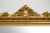 Antique Roman mirror in gilded, carved wood dating from the early 19th century. The mirror features a complex molded frame...