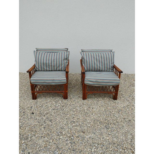 Pair of vintage armchairs. 2 vintage rattan armchairs with 3 cushions. the cushions have been remade by the previous...