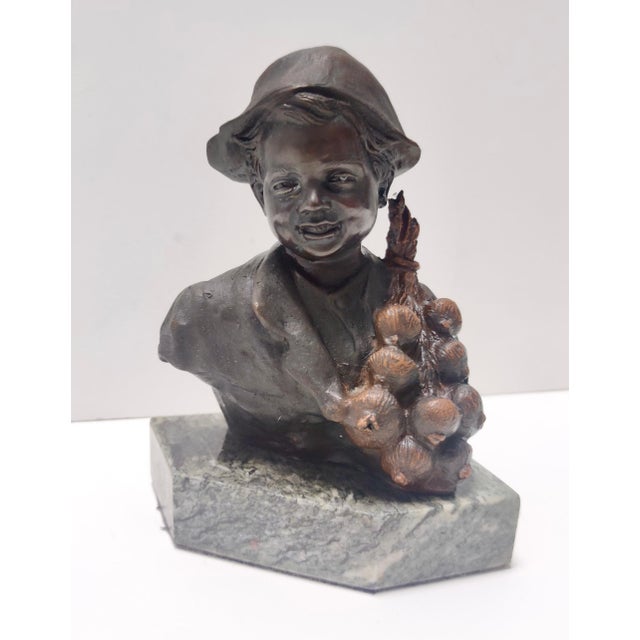 Made in Naples, Italy, 1920s. This child is made in polychrome bronze with a marble base. This item might show slight...