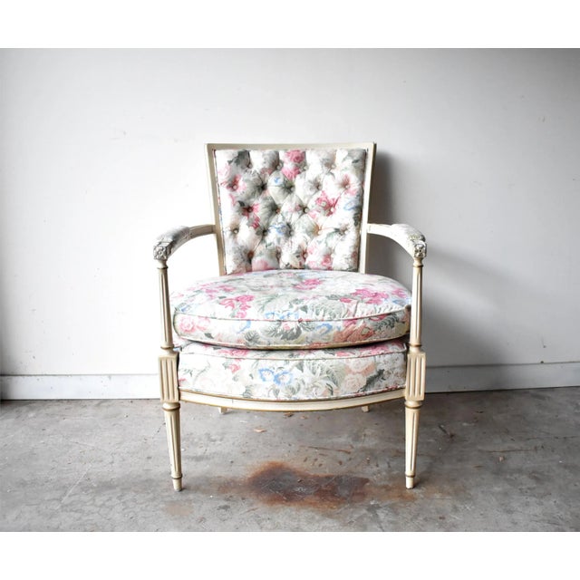 A vintage Louis XVI-style whitewashed wood bergere armchair, with a square button-tufted back, and a comfortable large...