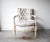 A vintage Louis XVI-style whitewashed wood bergere armchair, with a square button-tufted back, and a comfortable large...