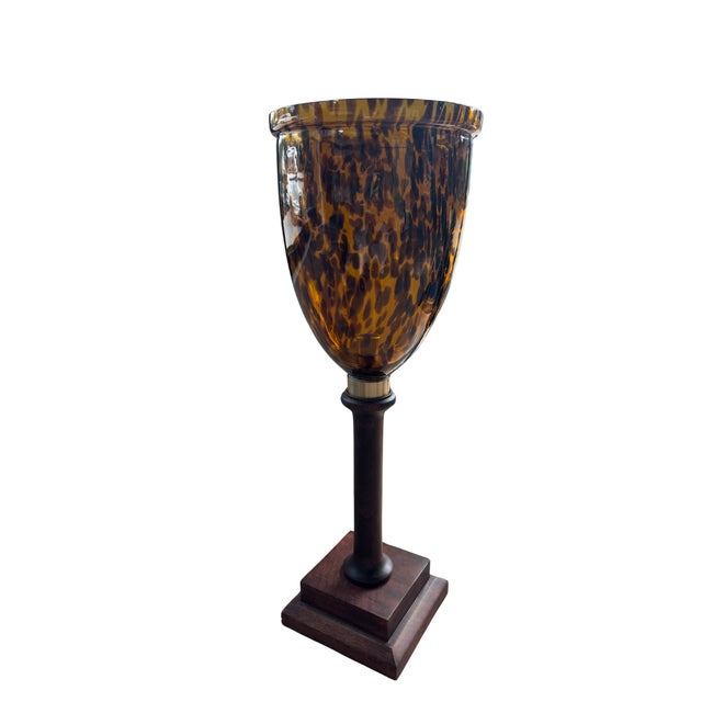 This versatile piece diffuses candlelight warmly and can double as a floral vase or accent piece. The rich walnut wood...