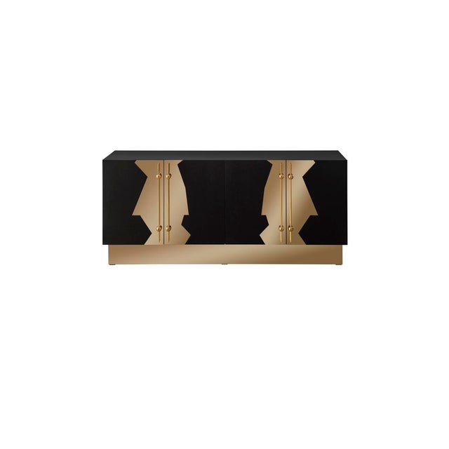 The Callista Sideboard features an Art deco-inspired design on the doors with a solid wood body and stainless-steel...