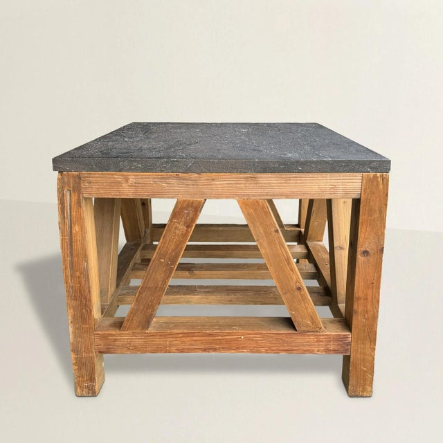 This 20th century American Modernist table, crafted from pine and crowned with a sleek gray marble top, is a captivating...
