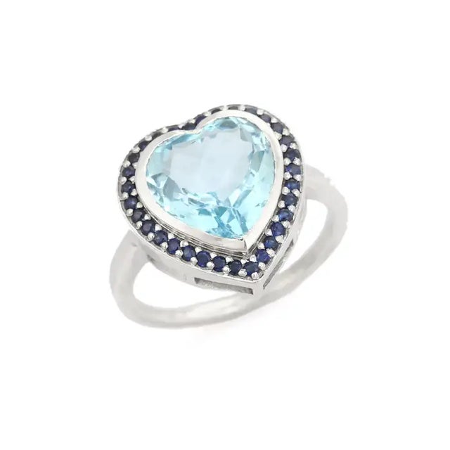 This Heart Shaped Blue Topaz and Sapphire Halo Promise Ring exquisite ring showcases a dazzling heart-cut blue topaz as...