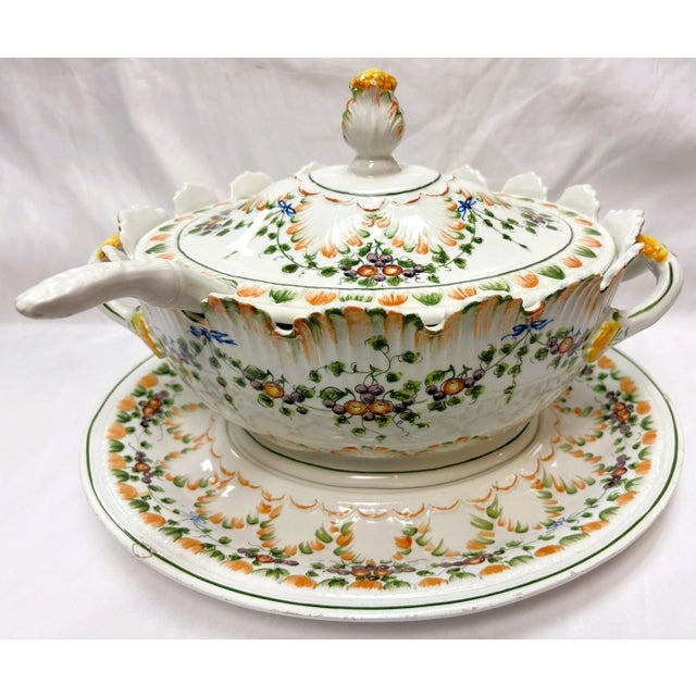 Pretty lidded ceramic soup tureen from the mid 20th century. It has a hand painted floral design in shades of yellow,...