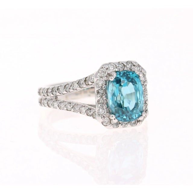 A Dazzling Blue Zircon and Diamond Ring! Blue Zircon is a natural stone mined in different parts of the world, mainly Sri...