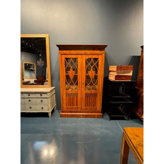 This 19th century German walnut Biedermeier cabinet exudes classic elegance and fine craftsmanship. Its stunning woodwork,...