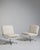 A collection of mid-century Space Age swivel chairs characterized by rounded forms and functional bases. These chairs...