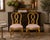 A striking pair of gilded Hollywood Regency side chairs in the style of Rose Tarlow, featuring sculptural ribbon-form...
