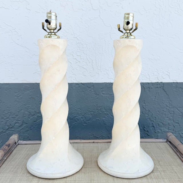 This striking pair of Postmodern table lamps features sculptural twisted column forms finished in a soft cream textured...