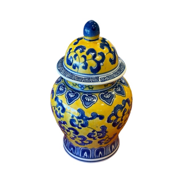A vibrant chinoiserie-style ginger jar featuring rich cobalt blue florals against a saturated yellow ground. The classic...