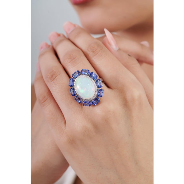 This vintage-style cocktail ring features a striking 10.96-carat combination of natural opal and blue sapphire, 18K white...