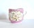 An antique, German porcelain mustache mug or cup, in porcelain with a wave base and ornate floral and dotted texture on...
