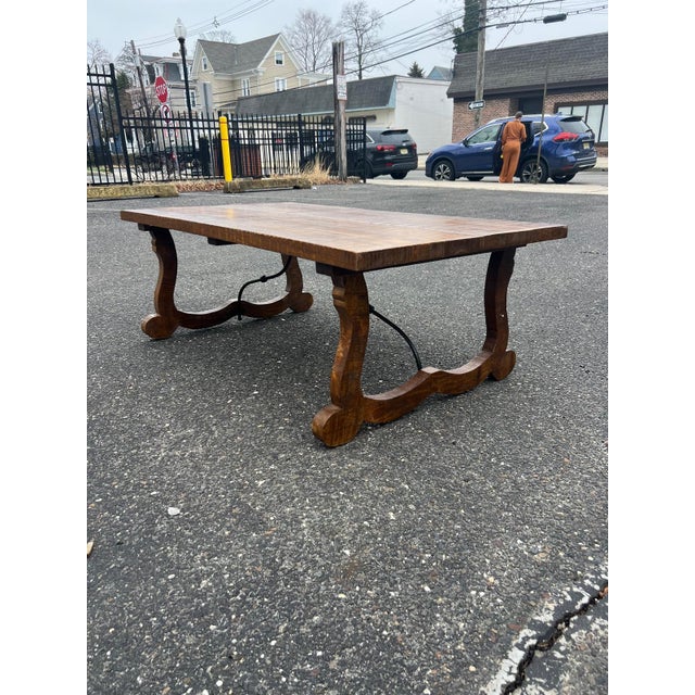 Handsome vintage solid wood trestle dining table showcasing beautiful natural wood grain and a warm, time-honored finish....