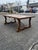 Handsome vintage solid wood trestle dining table showcasing beautiful natural wood grain and a warm, time-honored finish....