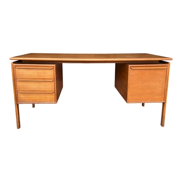 This elegant Danish modern teak desk showcases clean architectural lines and timeless mid-century craftsmanship....