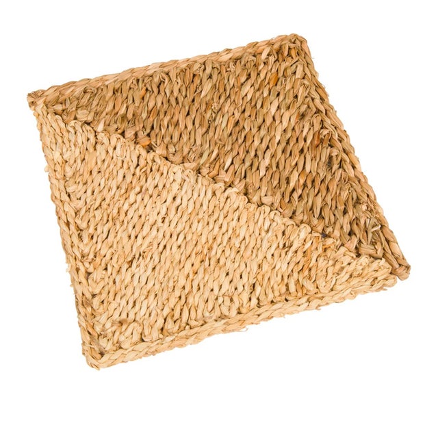A one-foot square comprised of natural seagrass and dried, off-white corn husk braided by hand and stitched into a...