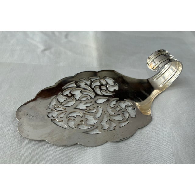 Add a touch of timeless English elegance to your table with this antique silver-plate toast server crafted by Pinder Bros....
