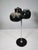 Standing ashtray in a space-age design, made of plastic and metal, with an integrated cigarette dispenser and lighter....