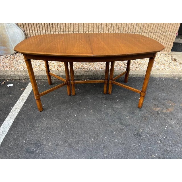 Mid Century Walnut Extendable Dining Table With 3 Leaves Features a boat- shaped top , 3 conforming leaf insertions raised...