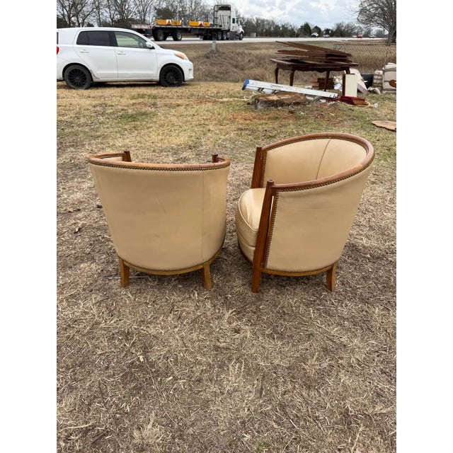 Classic pair of French Art Deco Solid Mahogany Barrel Back Club Chairs. The wood has been finished with a lustrous French...