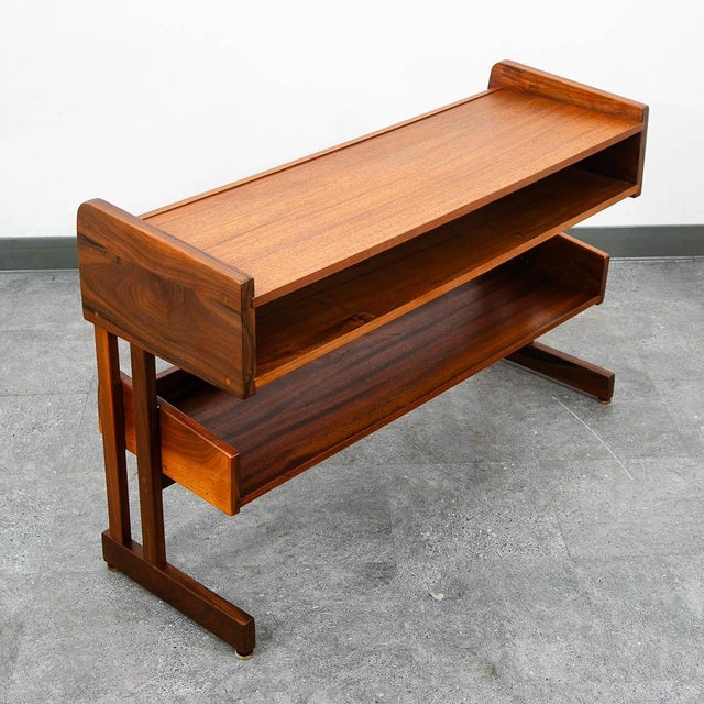 High quality console table featuring solid walnut construction and mahogany shelves. A unique compact design ideal for...