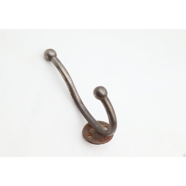 Vintage steel double arm wall hook with a brushed finish and ball tips. The original mounting screws are not available....