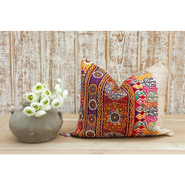 These colorful throw pillows are made from Rabari tribal dowry bags. The embroidery is on cotton and has intricate chain...
