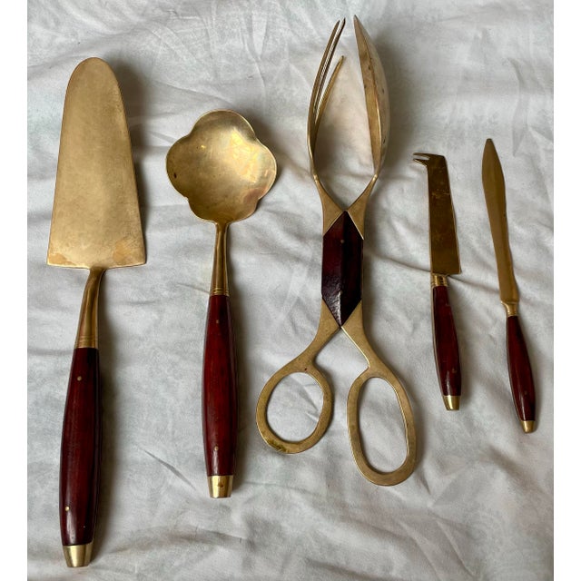 Here is a fantastic set of 5 serving pieces made of brass with rosewood handles. The tongs have one side that is a fork...