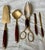 Here is a fantastic set of 5 serving pieces made of brass with rosewood handles. The tongs have one side that is a fork...