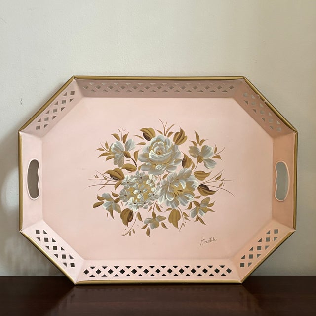 A beautiful mid-20th century hand painted pink tole serving tray with floral motif. Love the soft pink lacquer with gold...